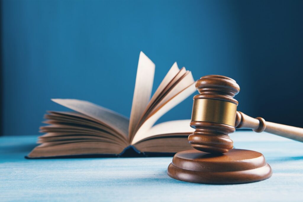 Judge's gavel and open law book representing access to legal counsel in criminal proceedings.