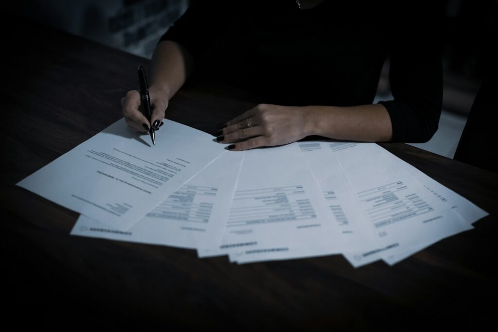 Person signing a legal document representing formal investigative procedure and procedural status.