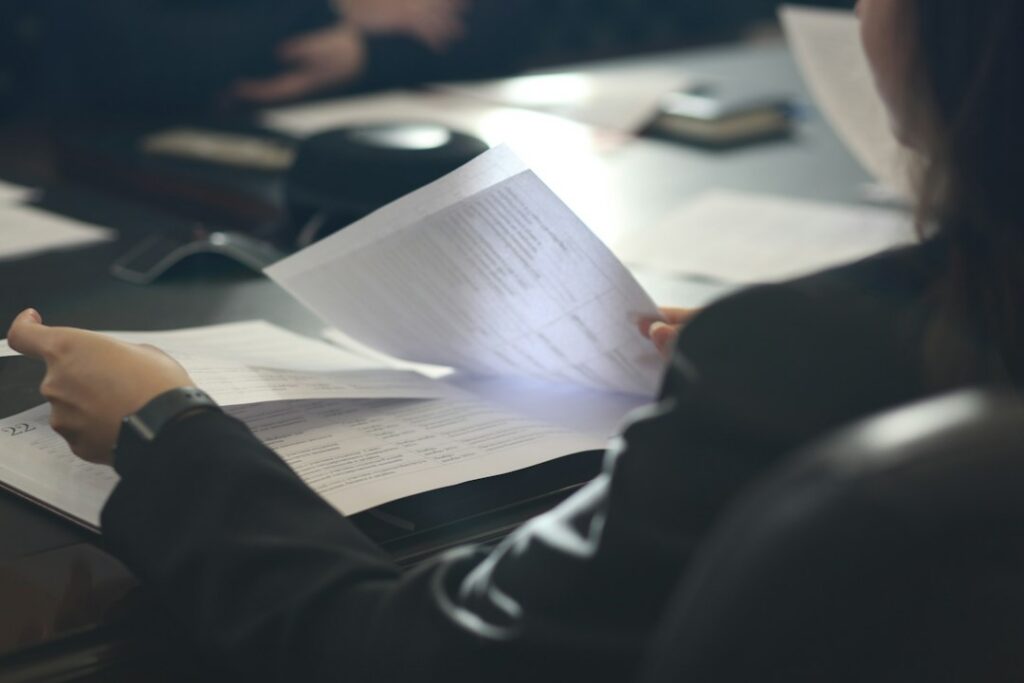 Person reading a document representing the right to information in criminal proceedings.